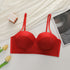Flat lay of red sparkle bustier bra with adjustable straps, styled with yellow tulips and decorative elements