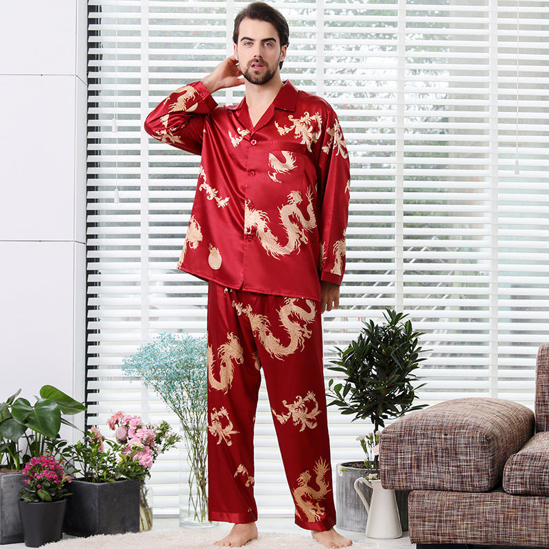 Burgundy red silk men's pajama set with intricate golden dragon print, styled with button-up top and relaxed pants