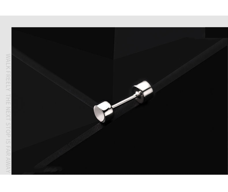 Artistic photo of silver cylindrical stud earring against dark geometric background
