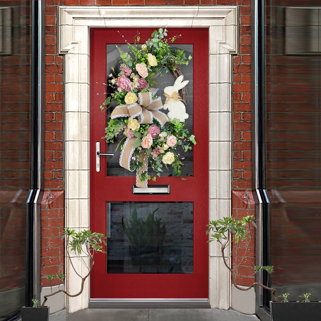 Easter wreath with floral and burlap bow details, hanging on a red door with a glass panel, creating a festive entrance.
