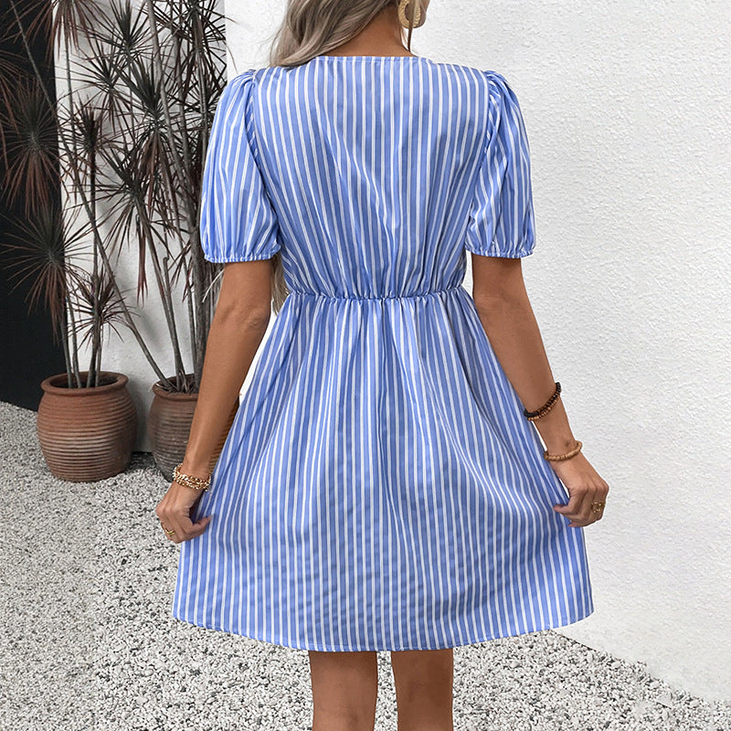 The back view of the blue striped dress, showcasing the elastic waistband and puff sleeves.