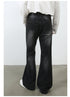 Back view of model wearing white button-up shirt with black washed wide-leg jeans and white sneakers on concrete floor
