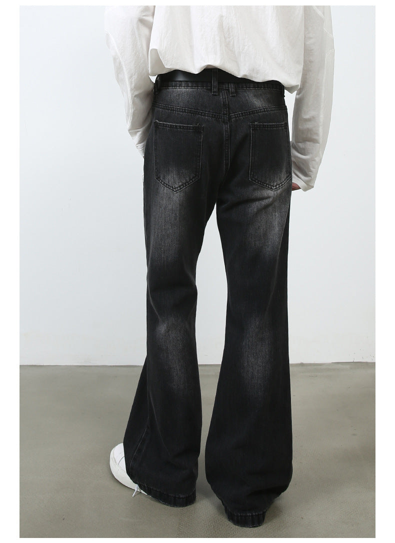 Back view of model wearing white button-up shirt with black washed wide-leg jeans and white sneakers on concrete floor