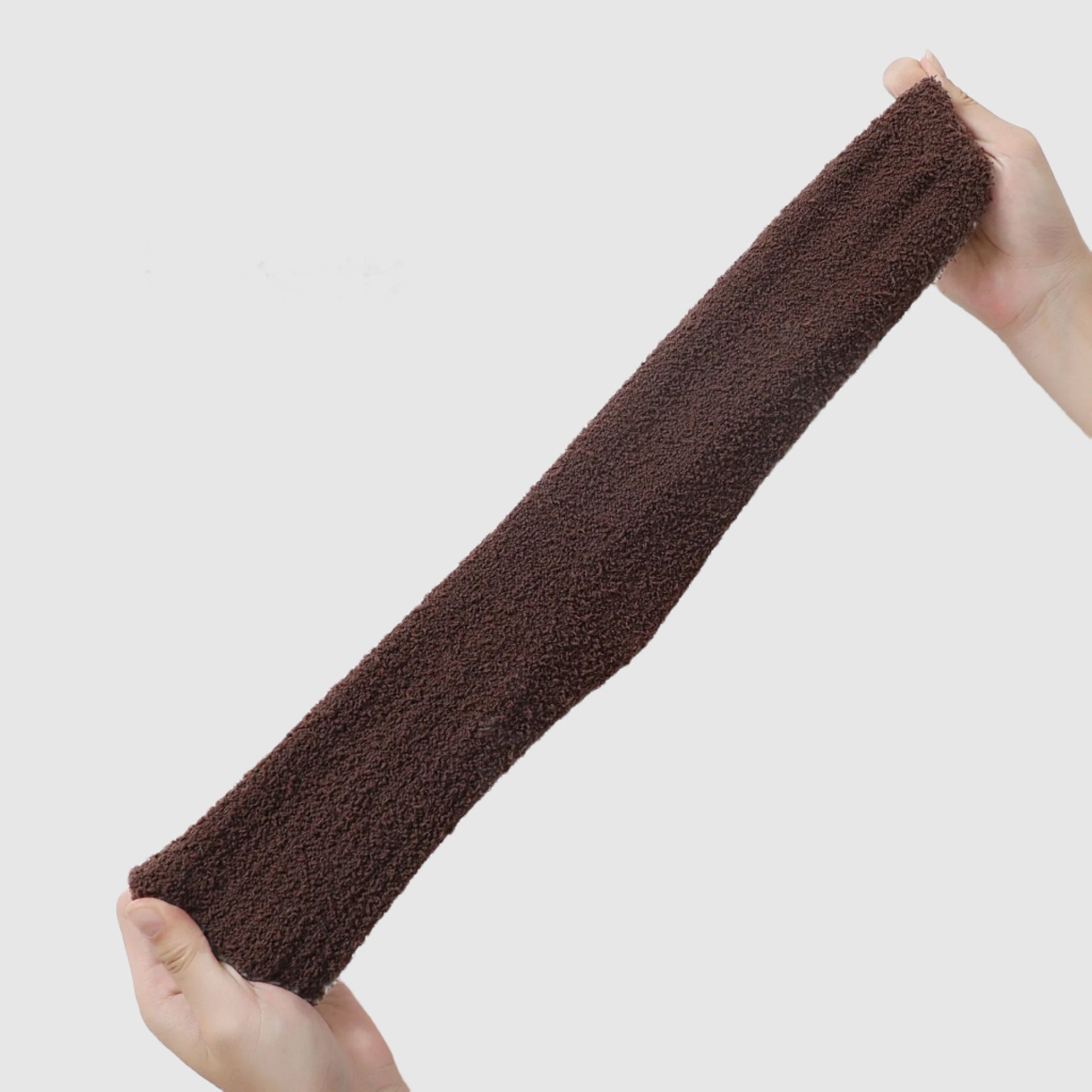 Brown fuzzy sock stretched out, highlighting its plush, textured knit fabric