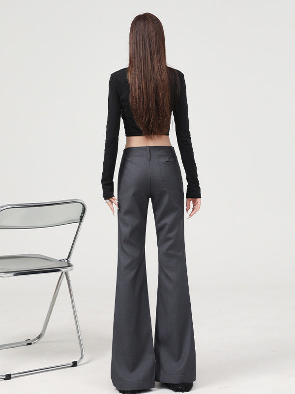 Back view, full-body shot of gray flared dress pants with curve-hugging fit.