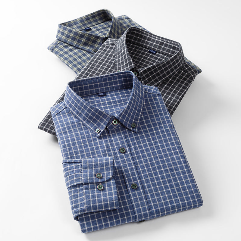 Three stacked flannel shirts in blue and gray patterns. Top shirt shows collar and pocket details