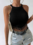 Black crochet-trim halter crop top styled with ripped denim shorts and chain strap bag.