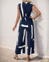 Back view of a women wearing navy sleeveless jumpsuit with a keyhole button closure, belted waist, and wide-leg pants.