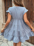 Back view of a woman in a baby blue ruffle sleeve babydoll dress, showing the flowy tiered skirt.