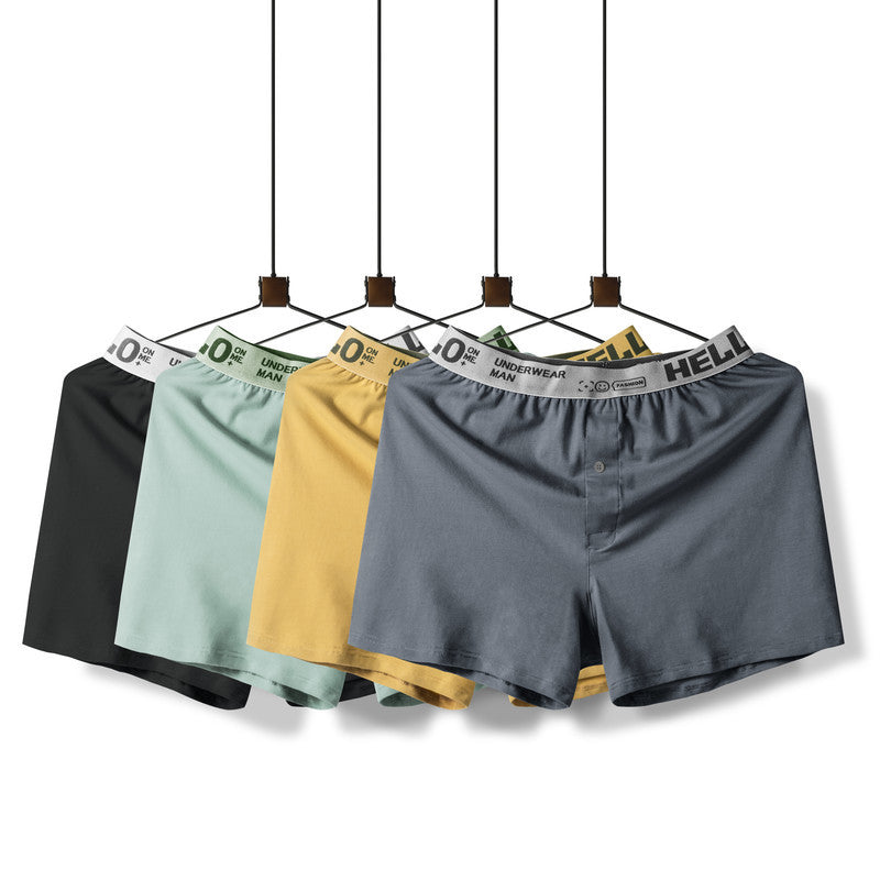 Four men's boxer shorts in black, mint, yellow and gray displayed on hangers showing front button fly design
