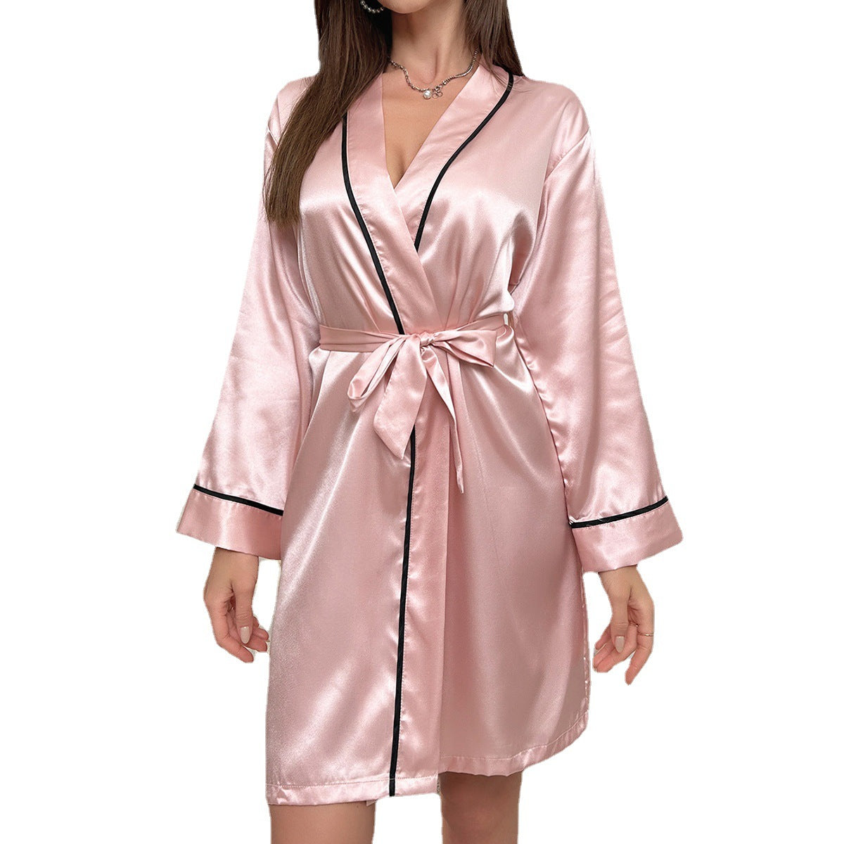 Blush pink satin robe with black trim detail, wide sleeves and belted waist, modern boudoir fashion