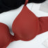Close-up of rust-colored padded bra cup showing smooth fabric texture