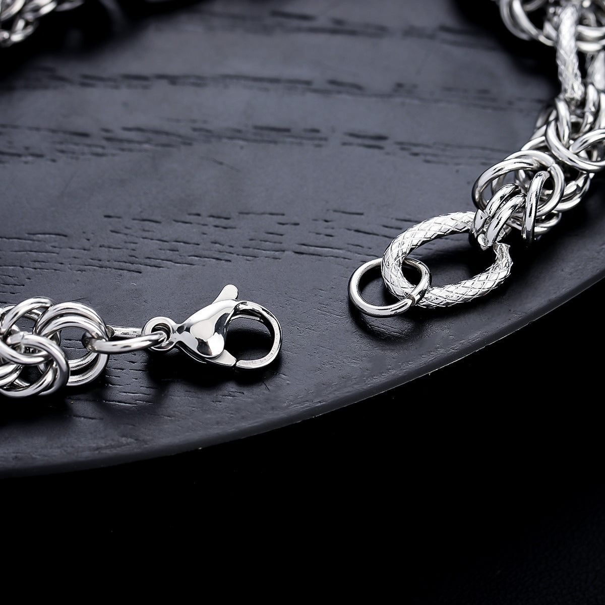 A close-up of the bracelet’s lobster clasp and textured chain links, highlighting its craftsmanship.