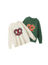 Product layout showing sweaters in white and forest green colorways with matching pretzel designs