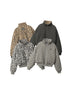Four reversible bomber jackets displayed together showing leopard print and quilted solid options in various colors including tan, gray and black against white backdrop