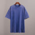 Blue t-shirt on a hanger against a gray background