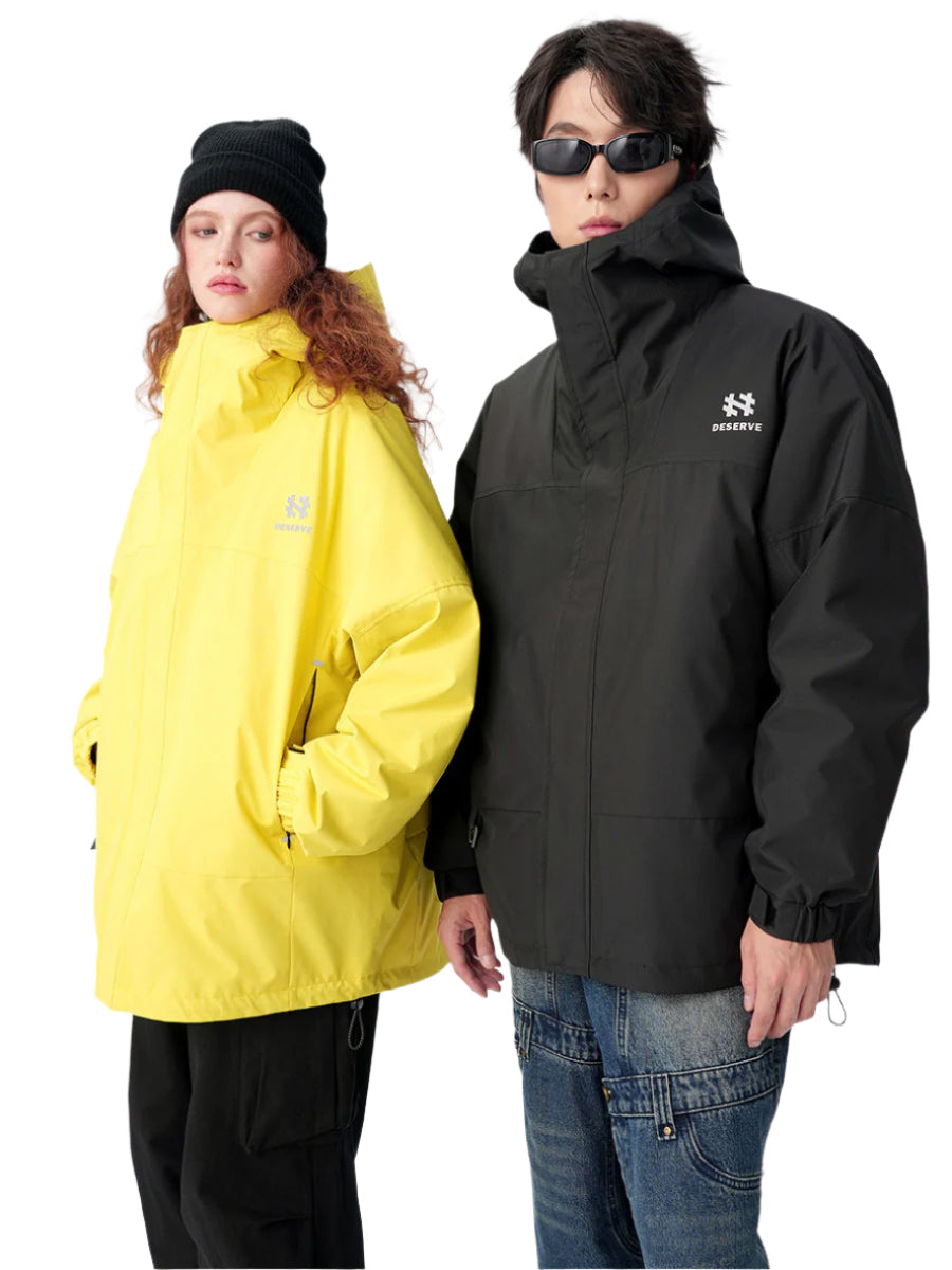 Model in black hooded jacket and yellow windbreaker with contrasting design elements, showcasing streetwear brand versatility