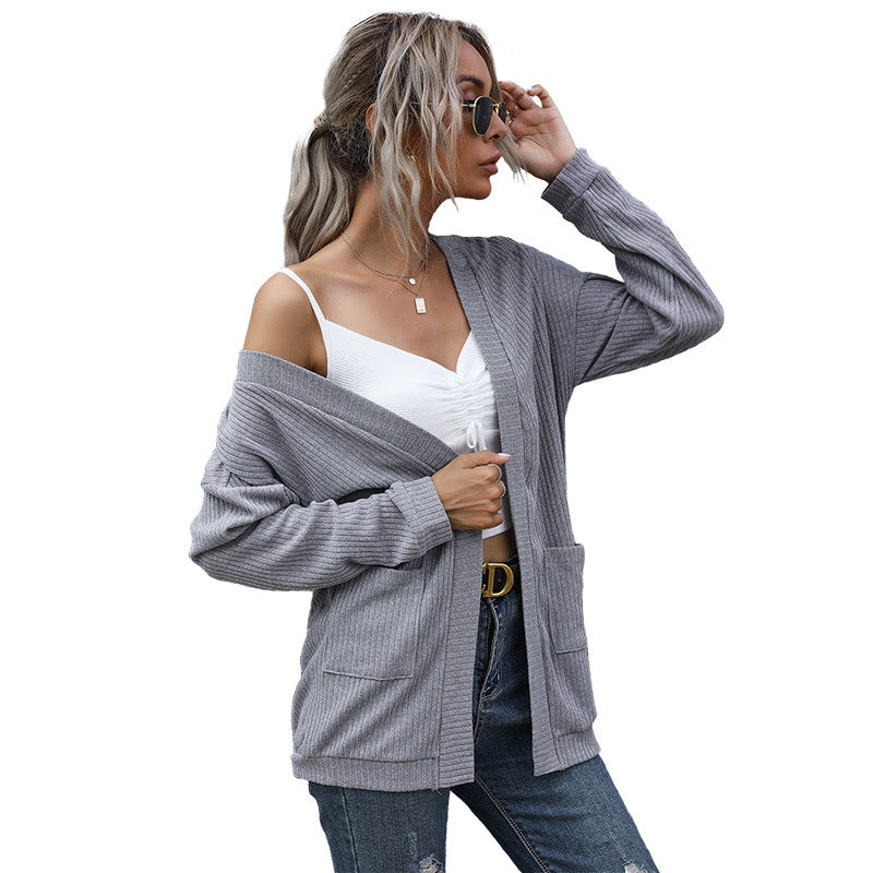 Styled look featuring grey oversized cardigan with side pockets and layered accessories
