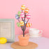 Striped Easter egg tree in a terracotta pot with multicolor pastel eggs, ideal for Easter table or shelf decorations.
