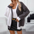 Oversized gray and white colorblock cardigan with ribbed trim, worn with black leather mini skirt