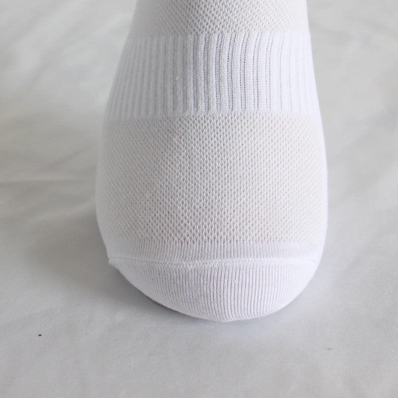 Close-up of white athletic sock showing detailed mesh ventilation pattern