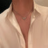 Silver necklace with crystal-encrusted angel wing cross pendant