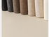 Close-up of knit leg warmers arranged in gradient from dark to light shades
