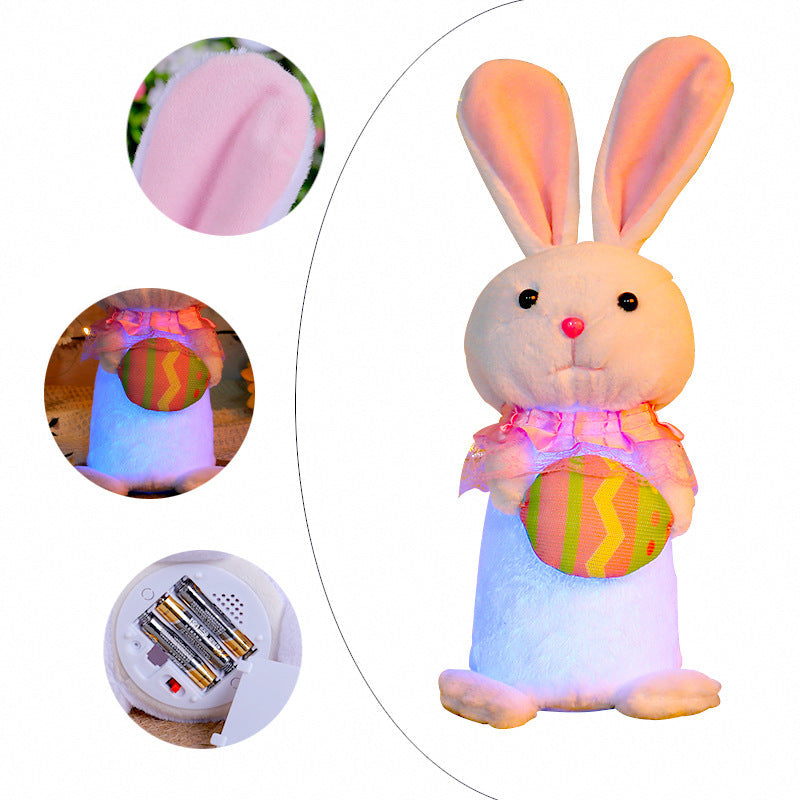 Close-up details of a pink Easter bunny plush with glowing LED lights, soft fabric ears, and a colorful egg in its hands, along with battery compartment view.