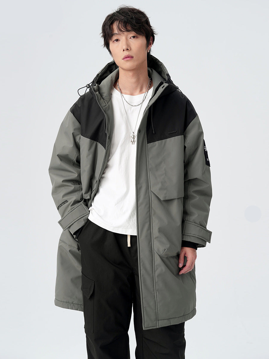 A man showing the back view of gray/black colorblock technical parka with hood detail against white background
