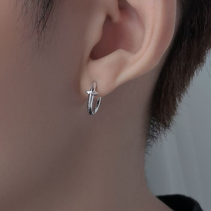 Silver star hoop earring worn on ear