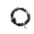Black and gray stone bracelet with silver moon charm and leaf pendant on white background