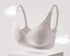 Seamless milk-gray bra with molded cups, soft gel support, and adjustable straps for all-day comfort.