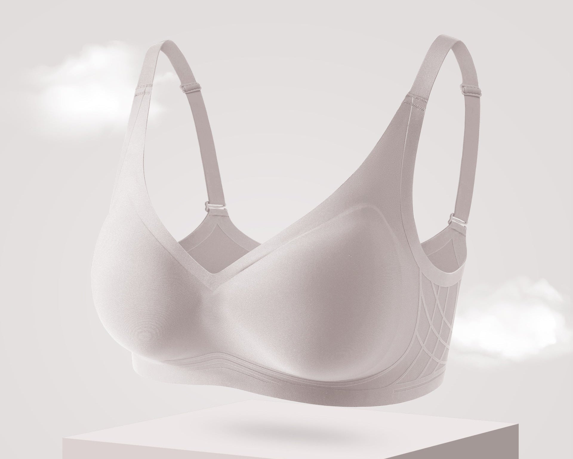 Seamless milk-gray bra with molded cups, soft gel support, and adjustable straps for all-day comfort.