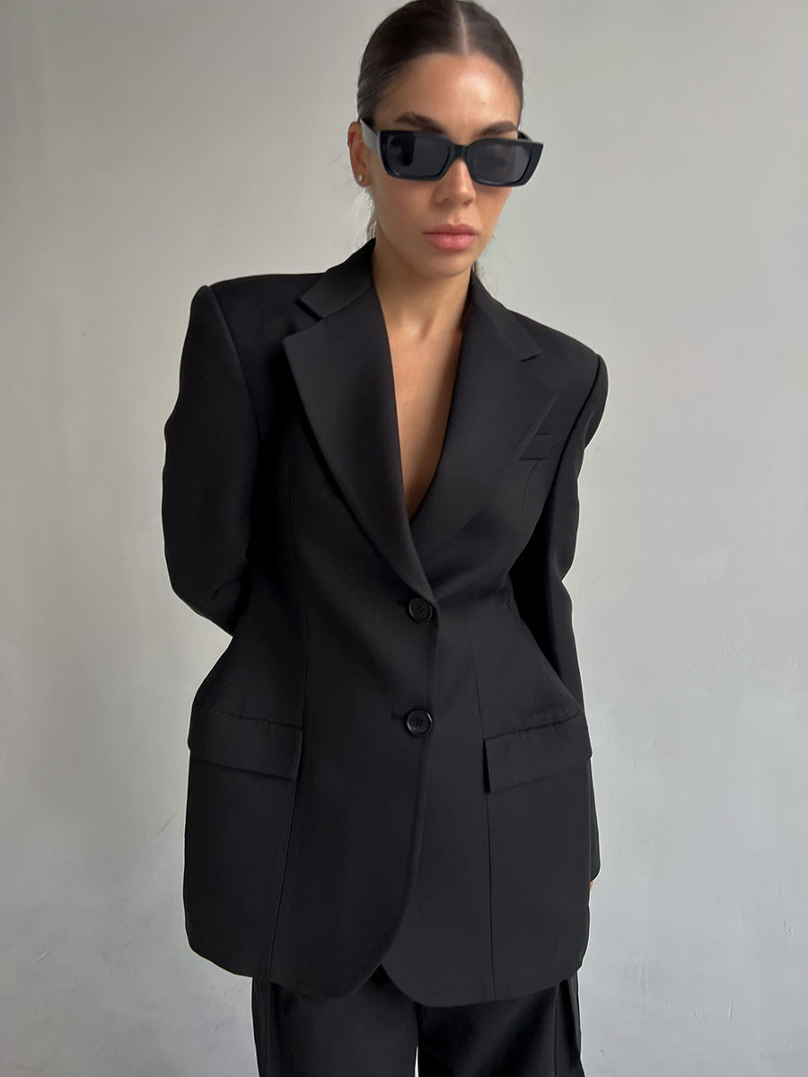 Boss Babe black blazer with structured shoulders and deep V-neck styling, paired with designer sunglasses for power dressing