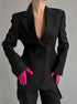 Professional black power blazer with hot pink gloves, showcasing tailored fit and double button closure for modern workwear