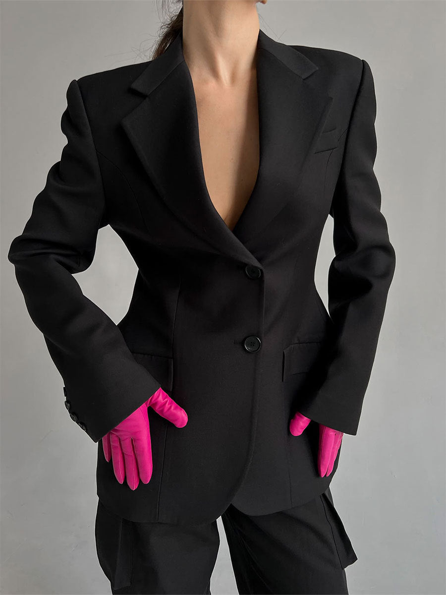 Professional black power blazer with hot pink gloves, showcasing tailored fit and double button closure for modern workwear