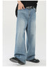 Action shot of light wash wide-leg jeans in motion, showing flowing silhouette with black shoes and oversized top