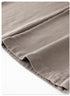 Close-up of grey sweatpants fabric fold showing material texture and stitching