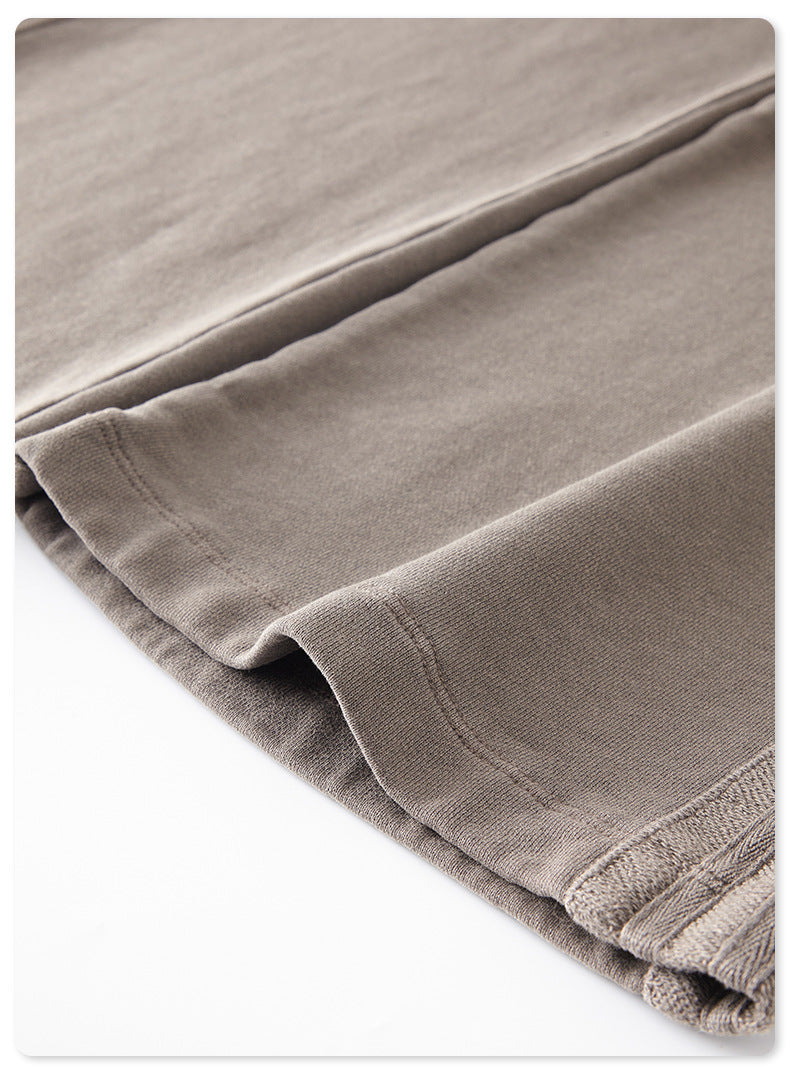Close-up of grey sweatpants fabric fold showing material texture and stitching