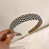 Black and white checkered padded headband in classic pattern
