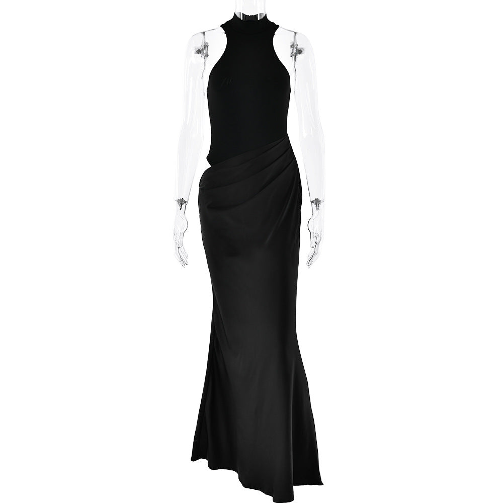 Black floor-length halter dress with form-fitting bodice and draped skirt, displayed on a mannequin with transparent arms
