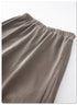 Detail of light grey sweatpants waistband showing elastic and pocket construction