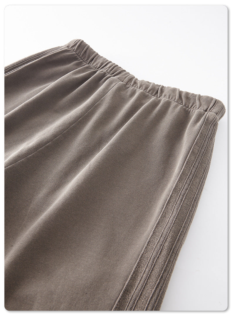 Detail of light grey sweatpants waistband showing elastic and pocket construction
