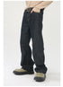 A model is posing with hand in pocket wearing dark denim straight-leg jeans with beige sweater, statement belt, and olive platform shoes