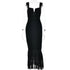 A black ruched bodycon dress with v-notch neckline and sheer tiered hem displayed on transparent mannequin against white background