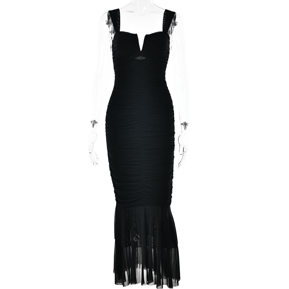 A black ruched bodycon dress with v-notch neckline and sheer tiered hem displayed on transparent mannequin against white background