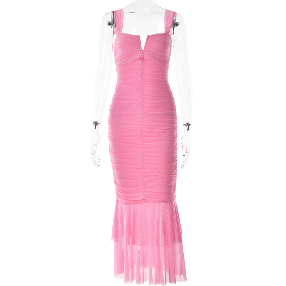 A pink ruched bodycon dress with sweetheart neckline and sheer tiered hem displayed on transparent mannequin against white background