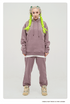 Model with platinum hair and neon yellow braids wearing a lilac purple sweatsuit with oversized hoodie and matching joggers