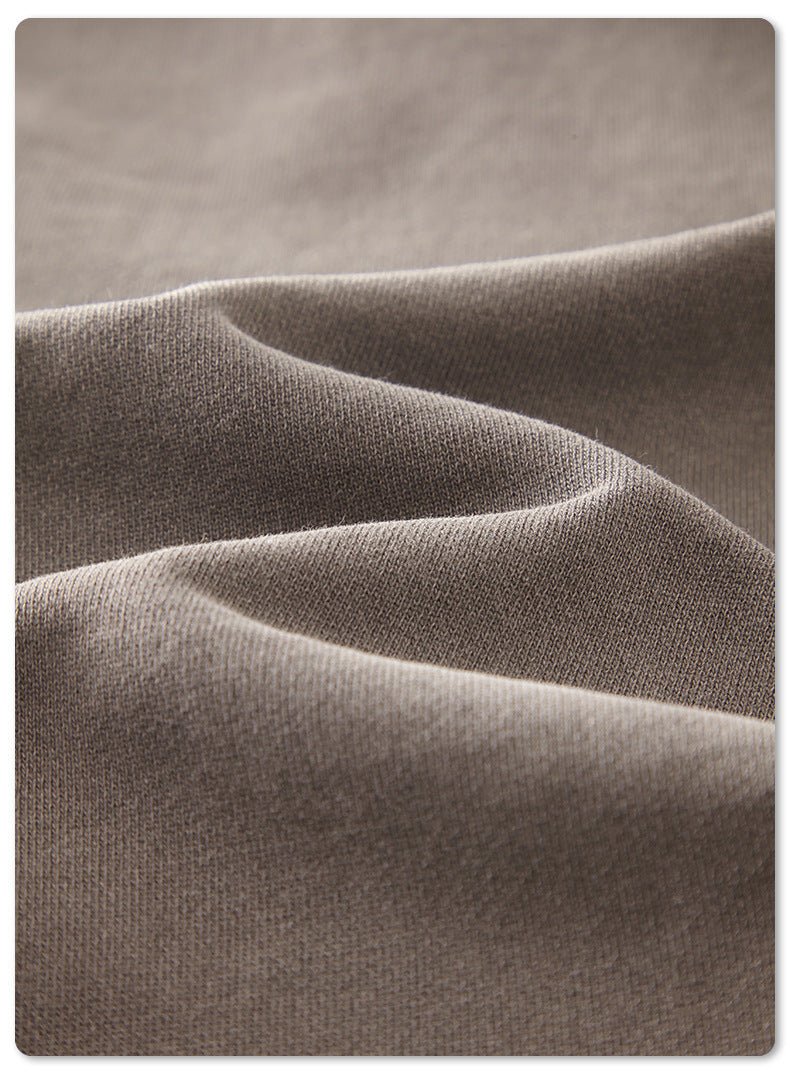 Macro detail of light grey cotton fabric showing knit texture
