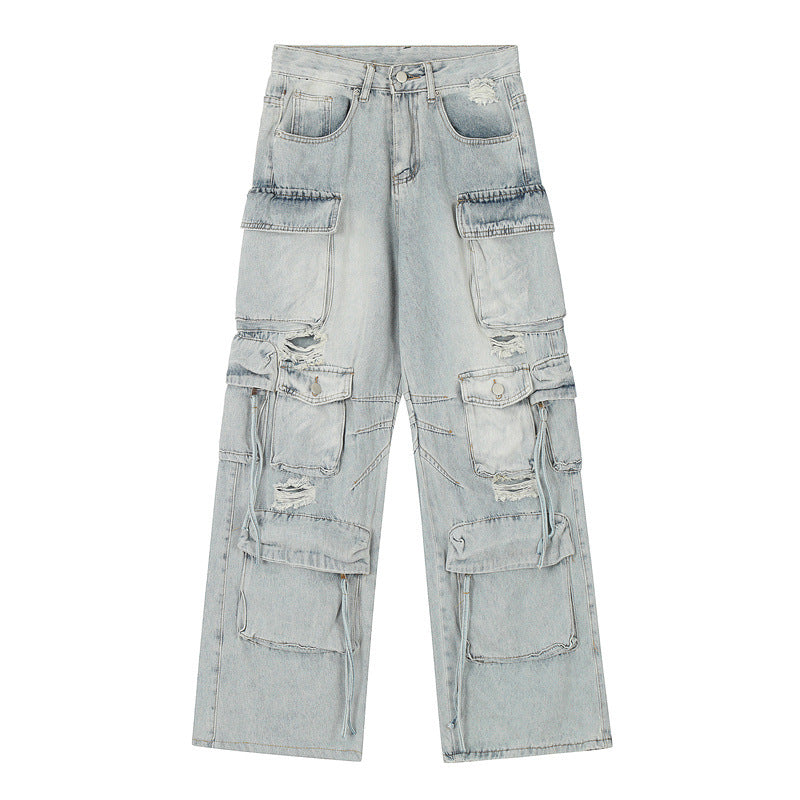 Light wash distressed cargo jeans with multiple utility pockets and drawstring details displayed flat against white background